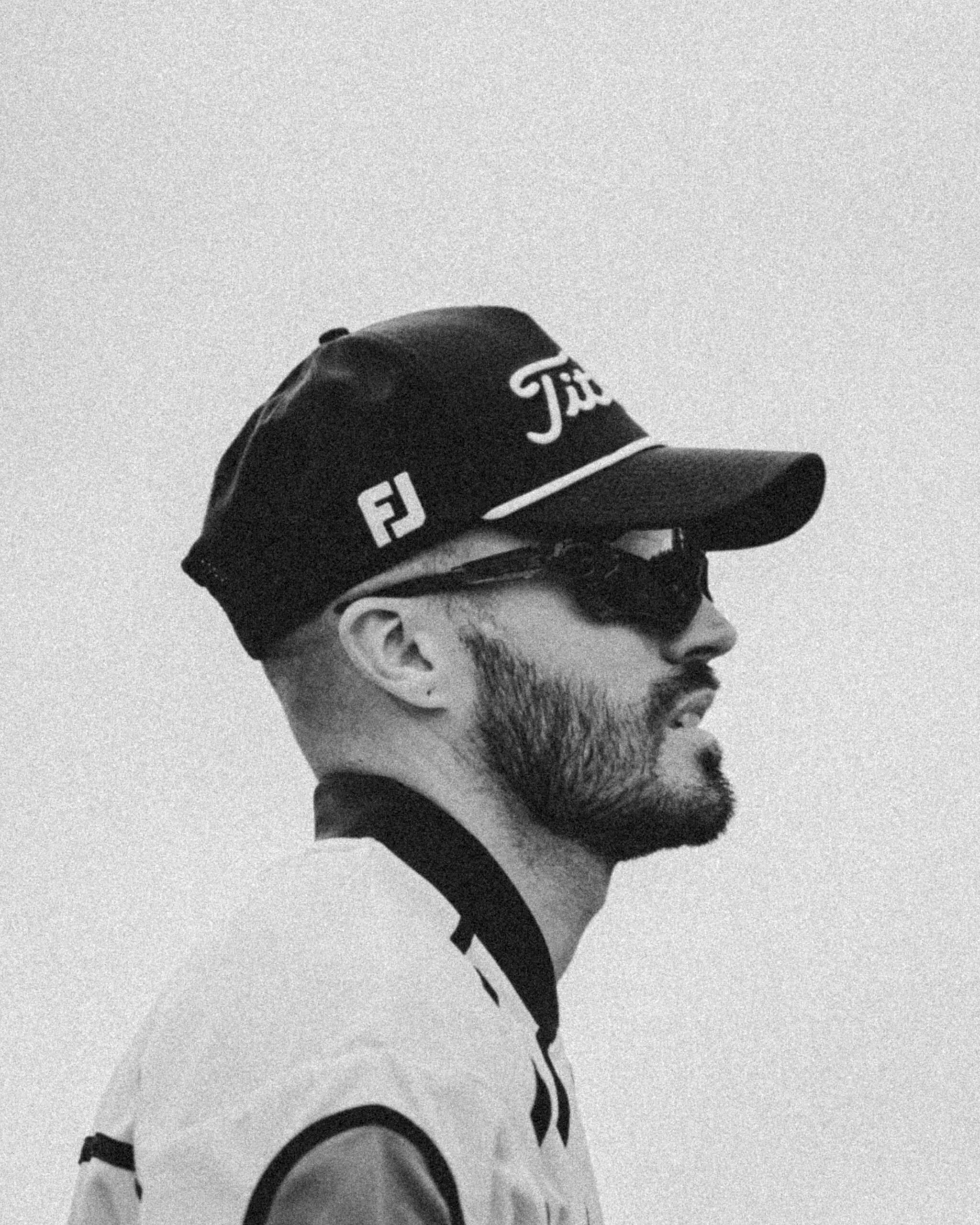 A moody portrait of a stylish golfer at The Links Social Tour event at Caledon Woods in Toronto